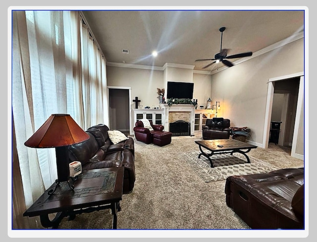 carpeted living room with ornamental molding, a tile fireplace, and ceiling fan