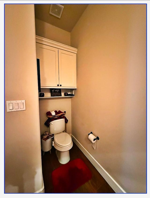 bathroom featuring hardwood / wood-style floors and toilet