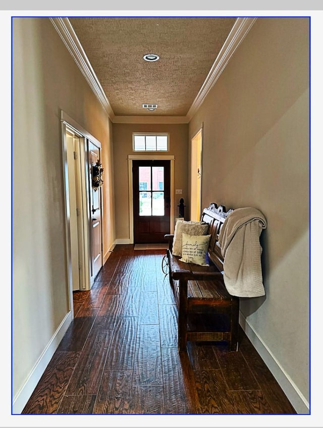 entryway with dark hardwood / wood-style flooring, crown molding, and a textured ceiling