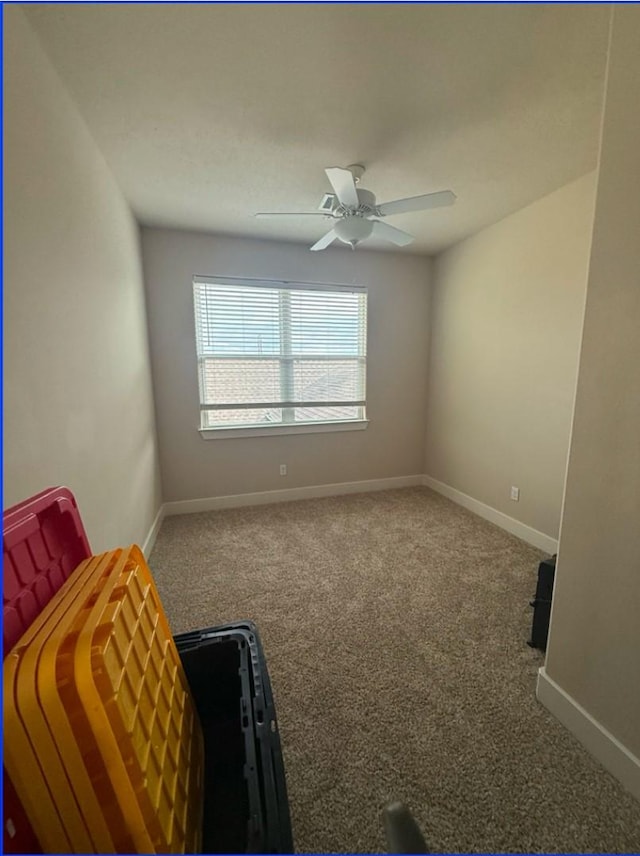 unfurnished room featuring ceiling fan and carpet flooring