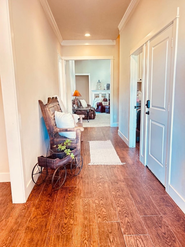 corridor featuring baseboards, wood finished floors, recessed lighting, and ornamental molding