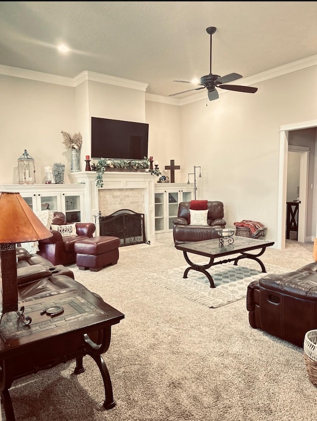 living room featuring a fireplace, crown molding, carpet, and a ceiling fan