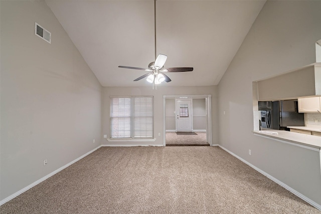 unfurnished living room featuring ceiling fan, lofted ceiling, and carpet flooring