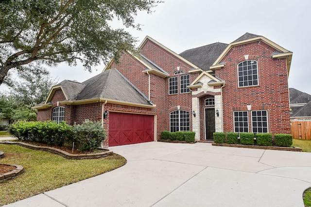 view of front property featuring a garage and a front lawn