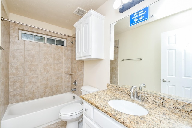 full bathroom with tiled shower / bath, tile patterned floors, toilet, and vanity