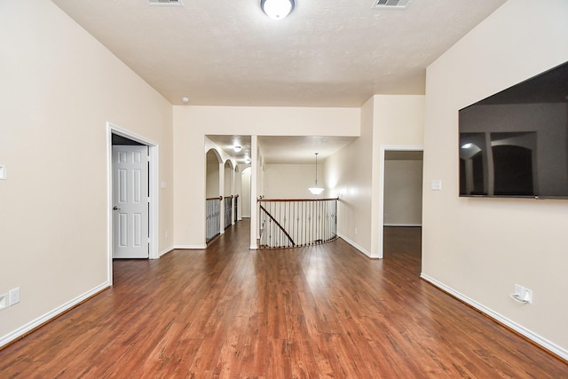 spare room with dark wood-type flooring