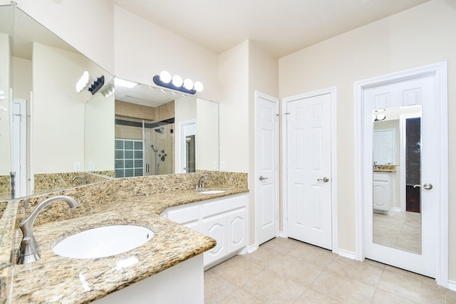 bathroom featuring vanity, tile patterned floors, and walk in shower