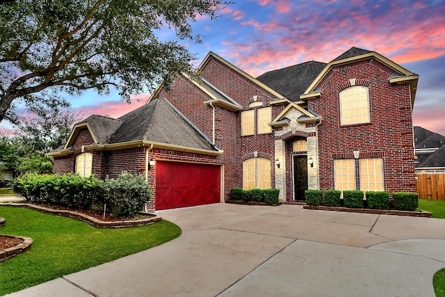 view of front of house with a garage and a lawn