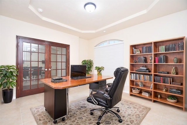 tiled office space with a raised ceiling and french doors