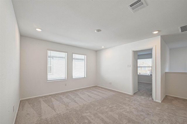 empty room featuring light colored carpet