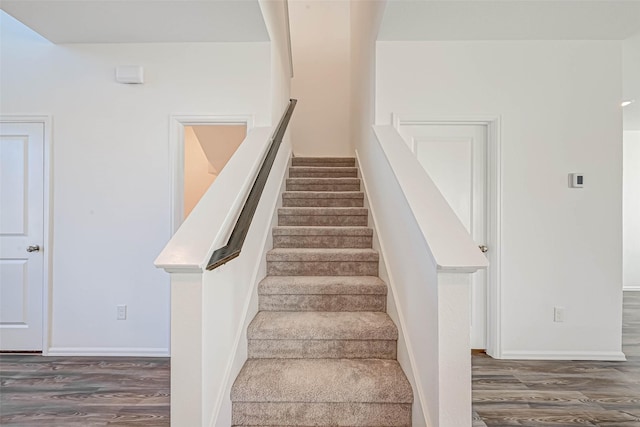 stairs featuring hardwood / wood-style flooring