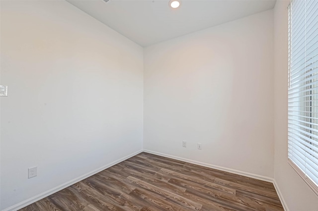 spare room featuring dark hardwood / wood-style floors