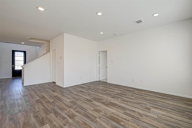 unfurnished room featuring dark wood-type flooring