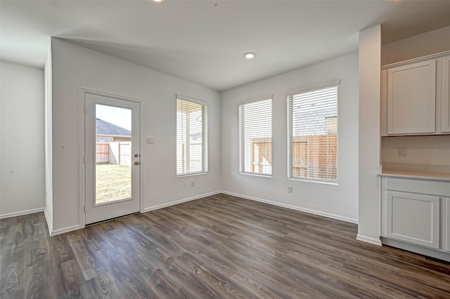 unfurnished dining area with dark hardwood / wood-style floors