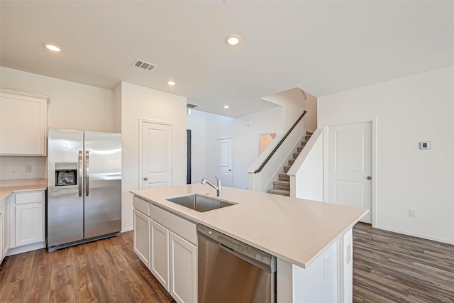 kitchen featuring dark hardwood / wood-style floors, sink, white cabinets, a kitchen island with sink, and stainless steel appliances