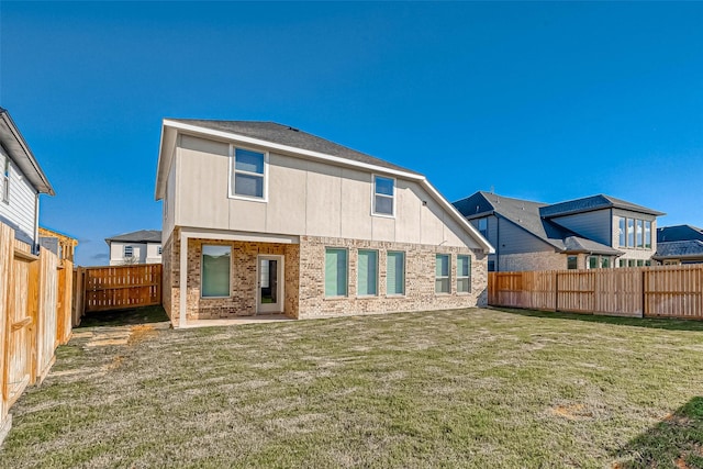 back of house with a yard and a patio area