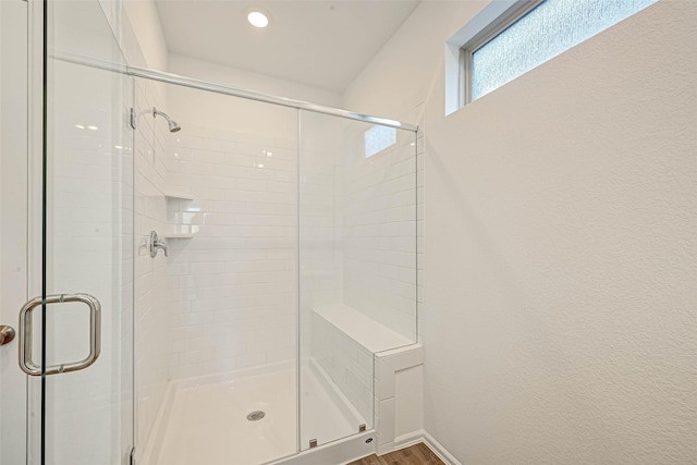 bathroom with hardwood / wood-style floors and walk in shower