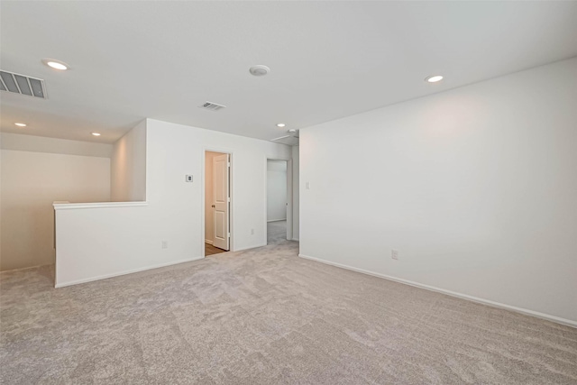 empty room featuring light colored carpet