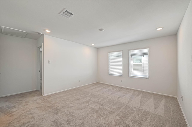 unfurnished room with light carpet