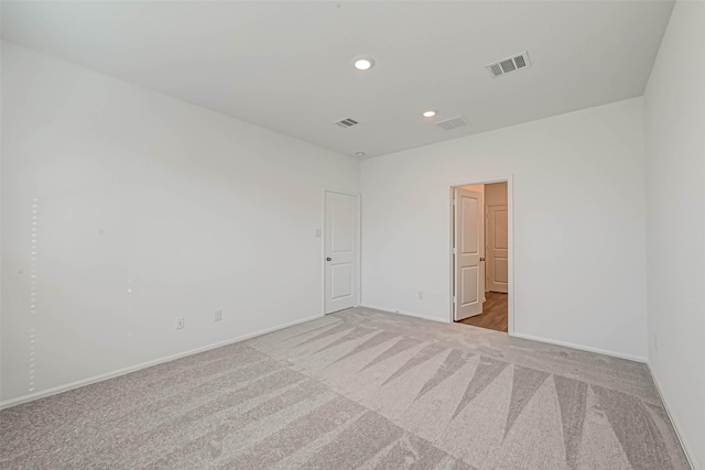 empty room featuring light colored carpet