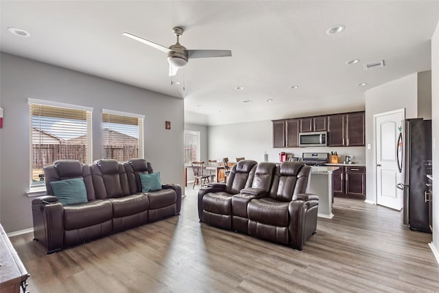 living room with hardwood / wood-style flooring and ceiling fan