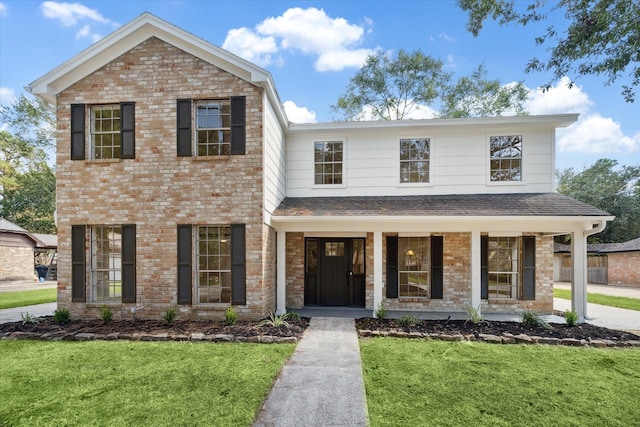 view of front of home featuring covered porch and a front lawn