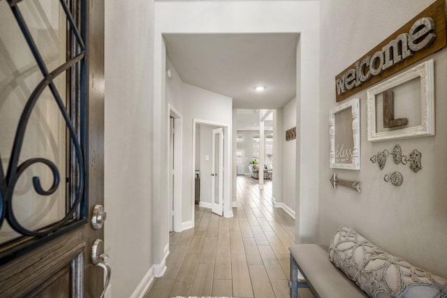 corridor with light hardwood / wood-style flooring