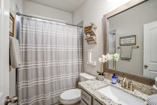 bathroom with vanity, a shower with shower curtain, and toilet