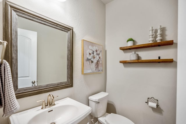 bathroom with sink and toilet