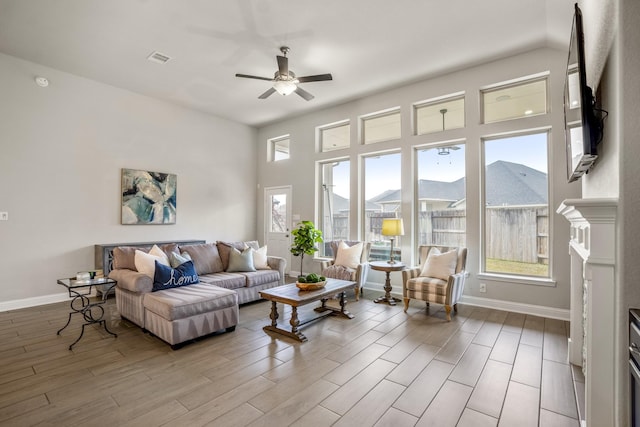 living room with ceiling fan and light hardwood / wood-style flooring