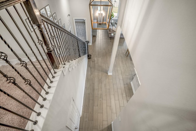 stairway featuring a chandelier