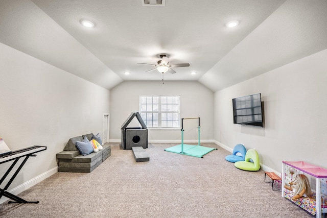 rec room with ceiling fan, vaulted ceiling, and carpet