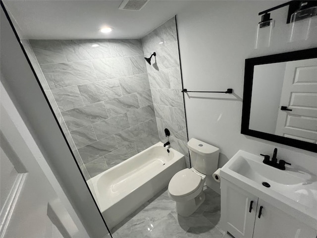 full bathroom featuring vanity, toilet, and tiled shower / bath combo