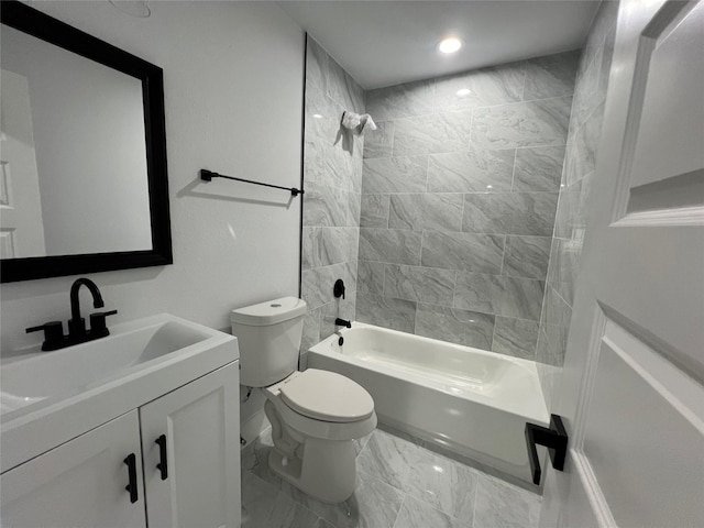 full bathroom featuring vanity, toilet, and tiled shower / bath