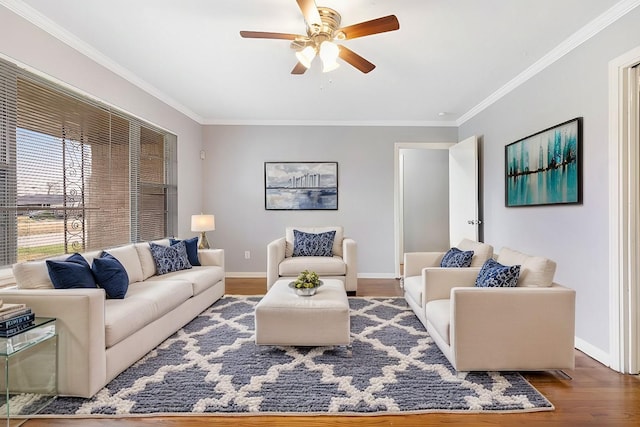 living room with hardwood / wood-style flooring, ceiling fan, and crown molding