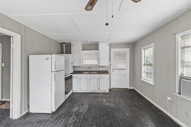 kitchen featuring white cabinetry, dark hardwood / wood-style flooring, sink, and white appliances