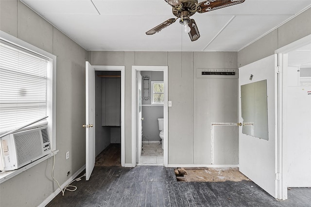 unfurnished bedroom featuring cooling unit, ensuite bath, and ceiling fan