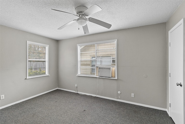 carpeted empty room with cooling unit, a textured ceiling, and ceiling fan