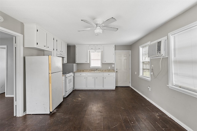 kitchen with sink, white appliances, a wealth of natural light, and white cabinets