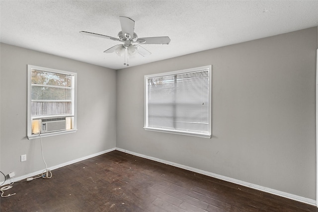 empty room with a textured ceiling, dark hardwood / wood-style floors, and ceiling fan