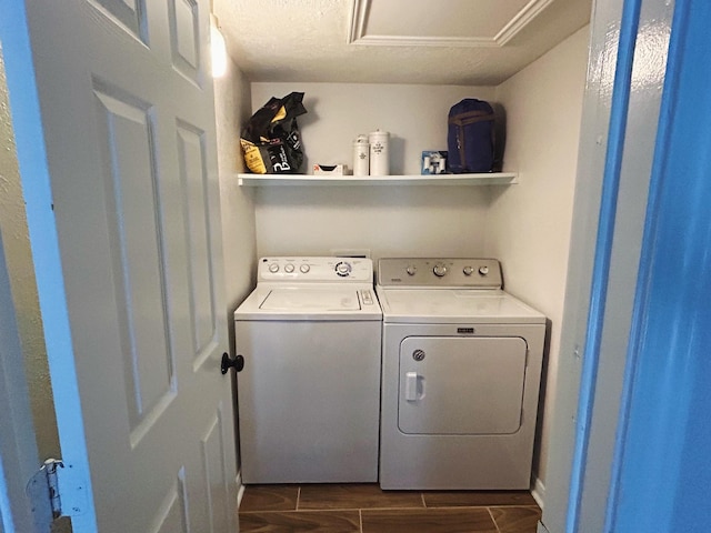 clothes washing area with washer and clothes dryer