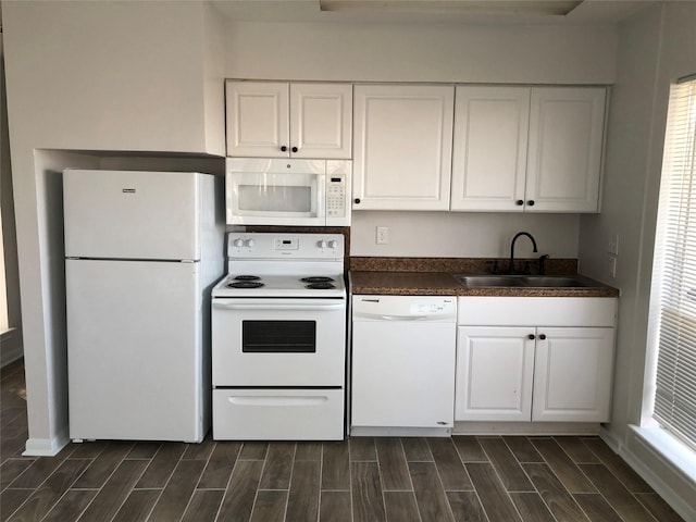 kitchen with white cabinetry, white appliances, and sink