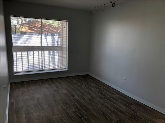 empty room featuring plenty of natural light and track lighting