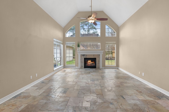 unfurnished living room with a fireplace, high vaulted ceiling, and ceiling fan