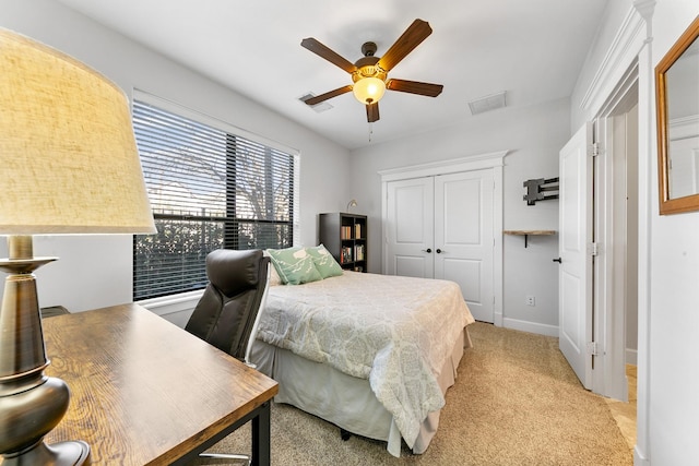 bedroom with light carpet, a closet, and ceiling fan