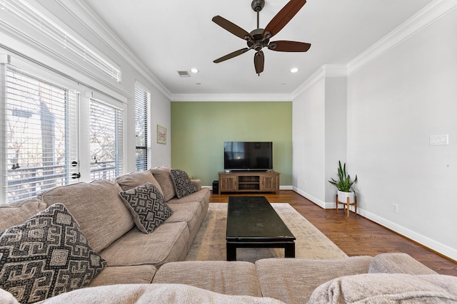 living room featuring dark wood-type flooring, ceiling fan, and ornamental molding