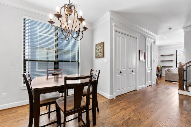 dining room featuring ornamental molding, a chandelier, and hardwood / wood-style floors