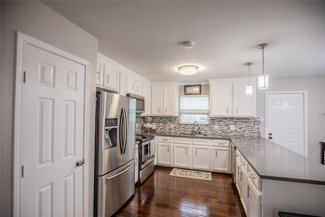 kitchen with sink, white cabinets, hanging light fixtures, kitchen peninsula, and stainless steel appliances