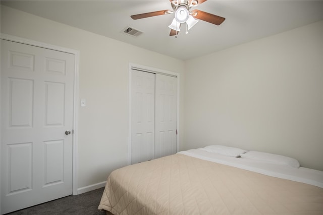 carpeted bedroom with a closet and ceiling fan