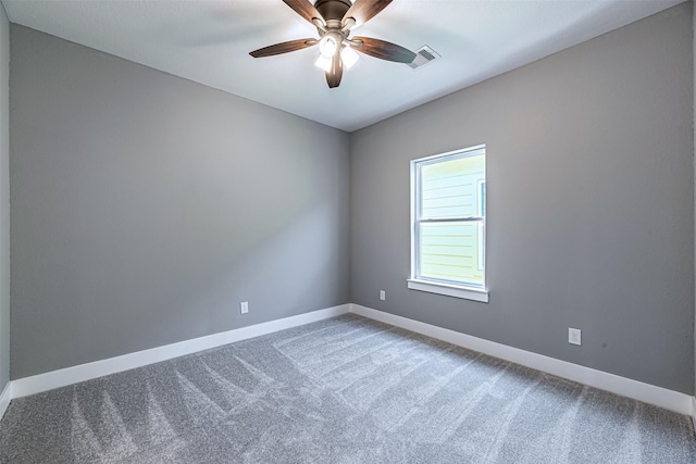 carpeted spare room with ceiling fan